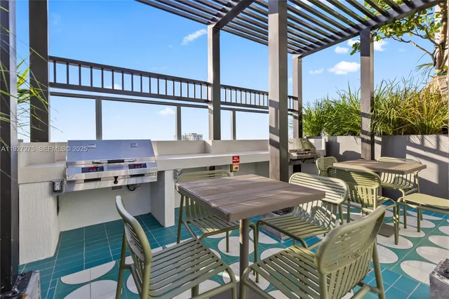 a patio with water view and outdoor seating