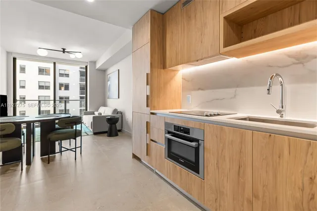 a kitchen with sink cabinets and outdoor view