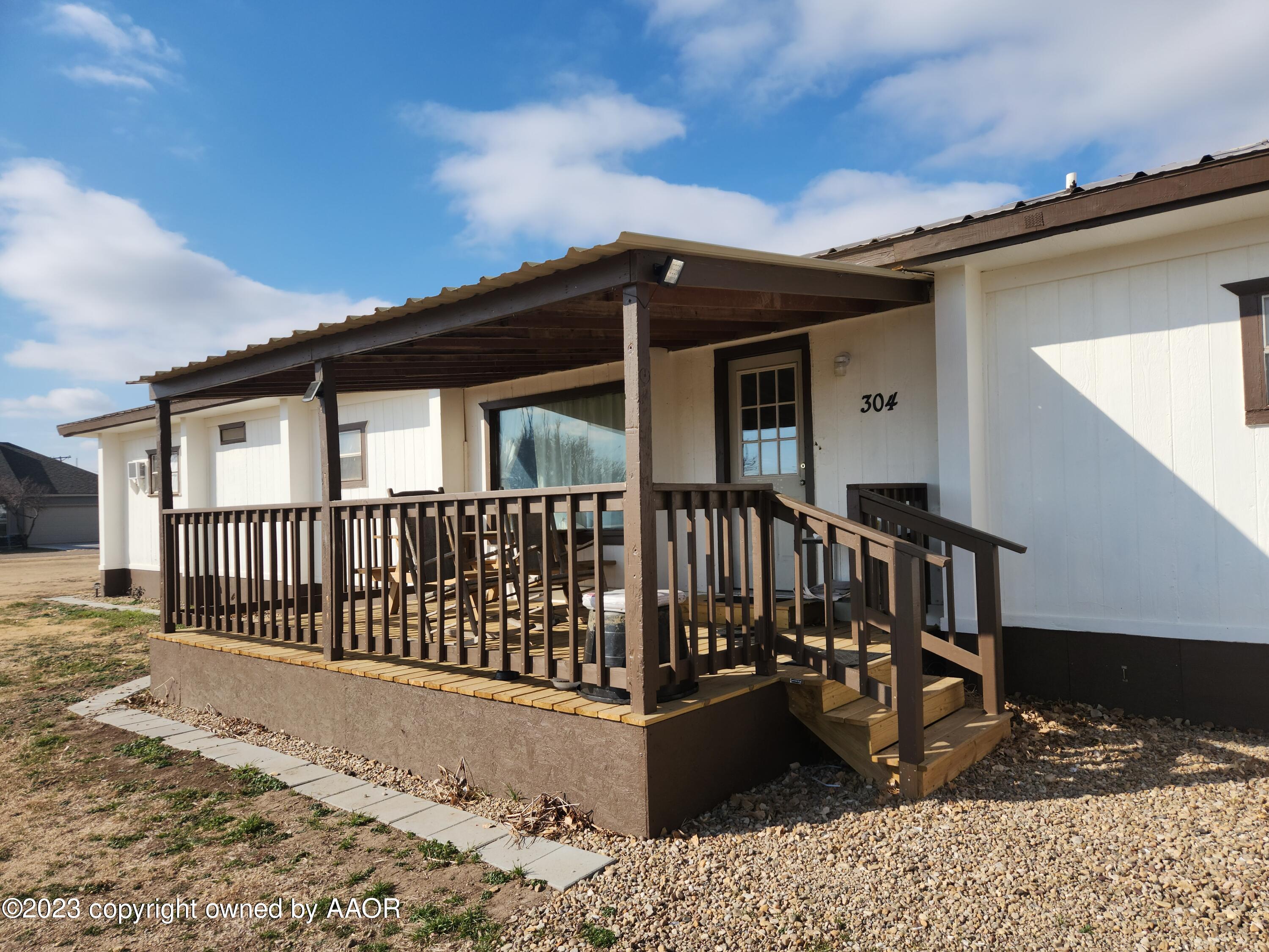 a view of a house with wooden fence