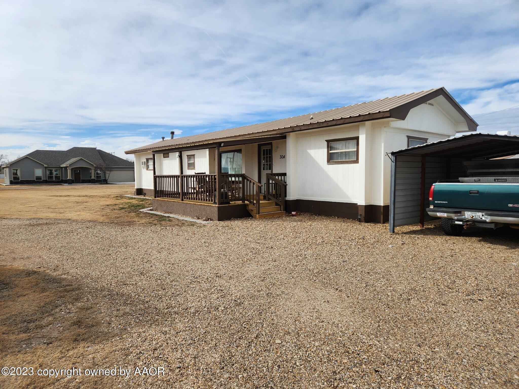 304 Collins Street Claude, TX 79019 - Photo 2 of 11 a house view with a garden space