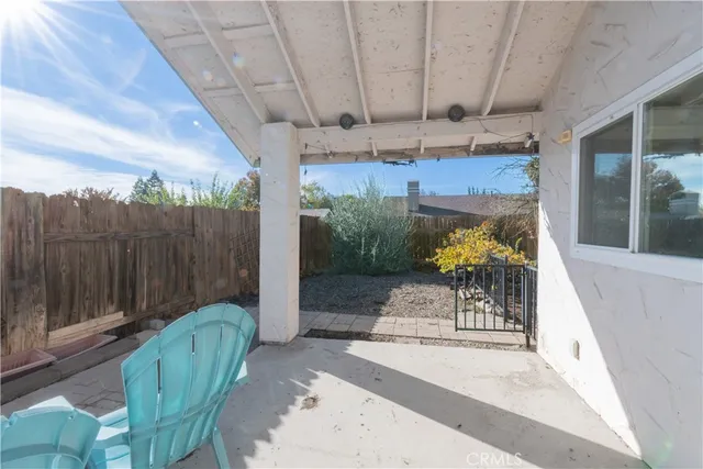 a view of a chairs and table in the patio