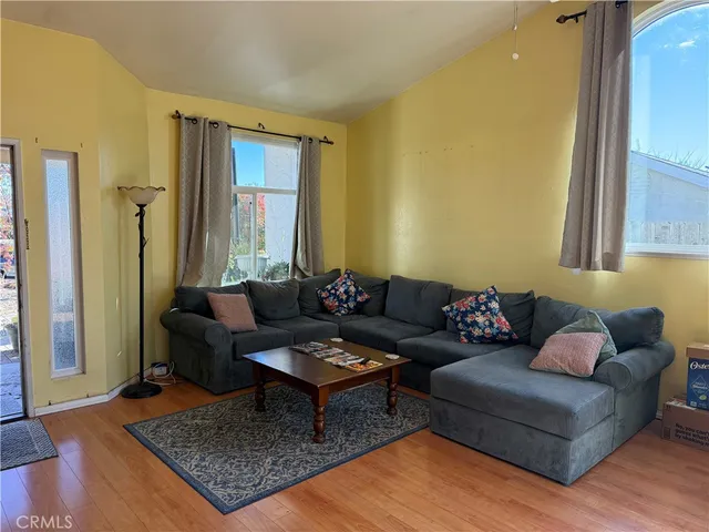 a living room with furniture rug and wooden floor