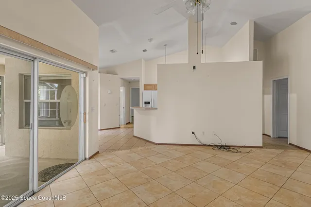 a view of a kitchen with refrigerator and cabinet