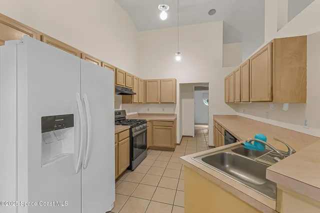 a kitchen with a sink cabinets and stainless steel appliances