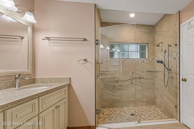 a bathroom with a double vanity sink and a mirror