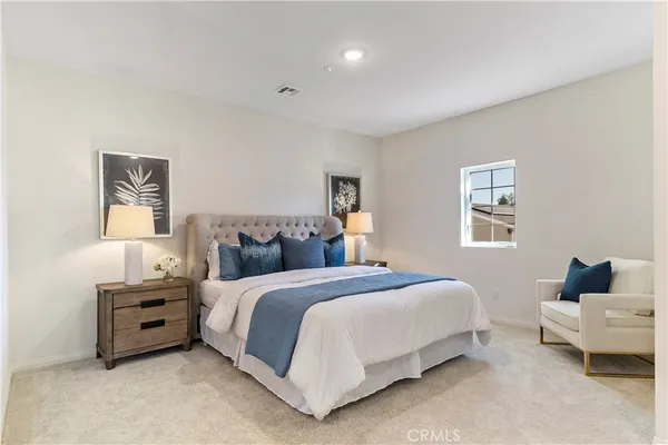 a bedroom with a bed and cabinets