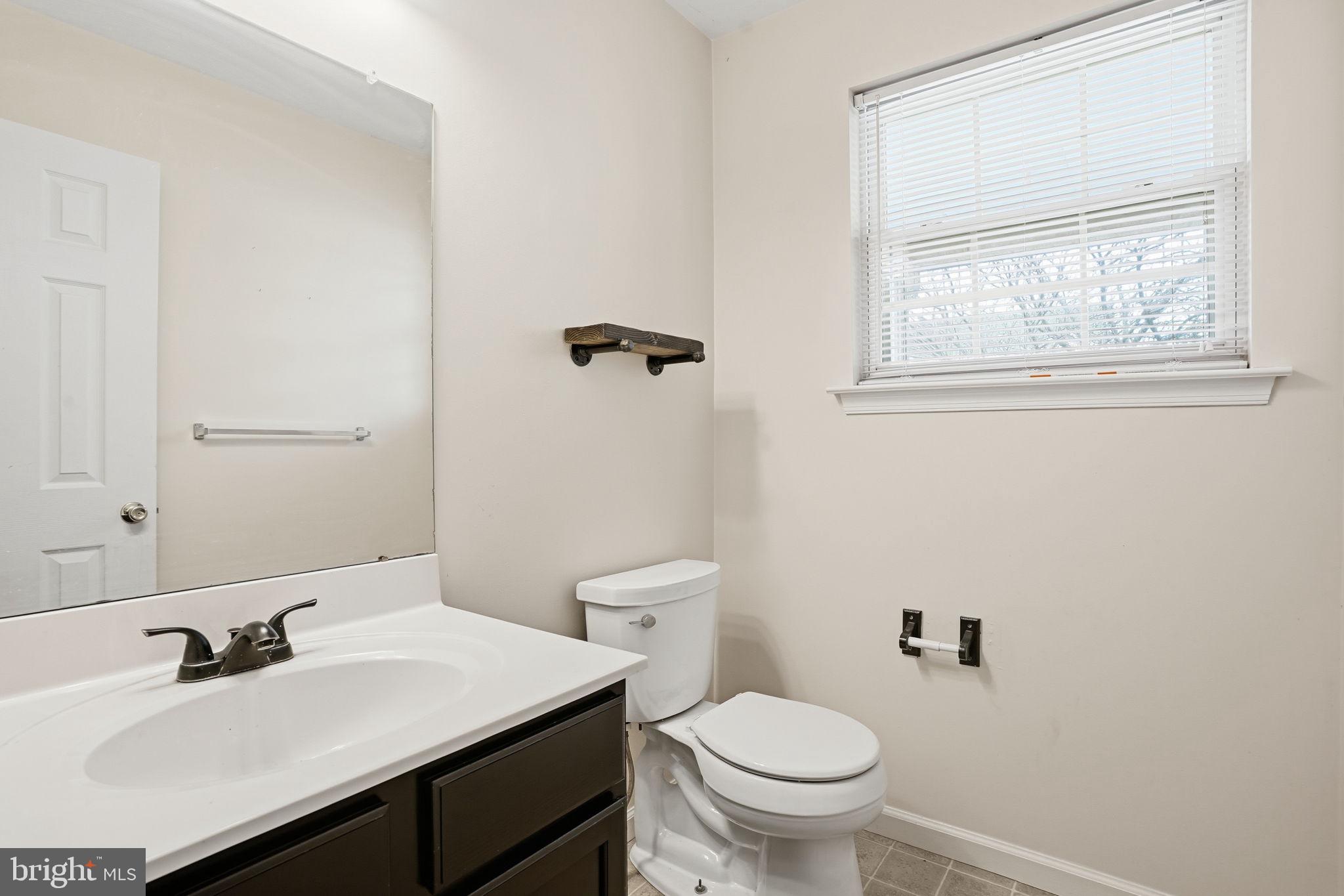 737 Seminary Street Pennsburg, PA 18073 - Photo 13 of 30 a bathroom with a sink toilet and a mirror