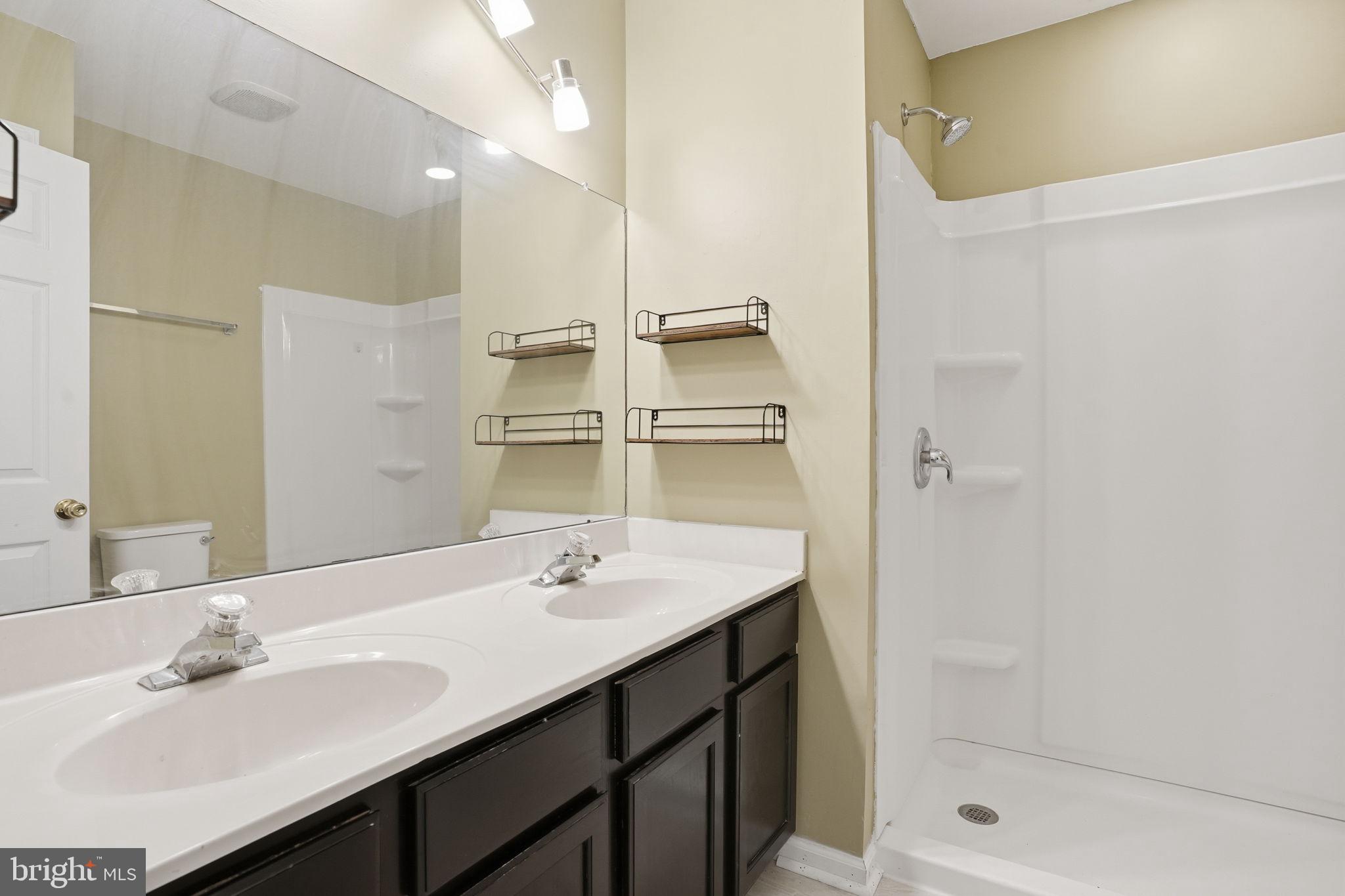 737 Seminary Street Pennsburg, PA 18073 - Photo 17 of 30 a bathroom with a shower sink vanity and mirror