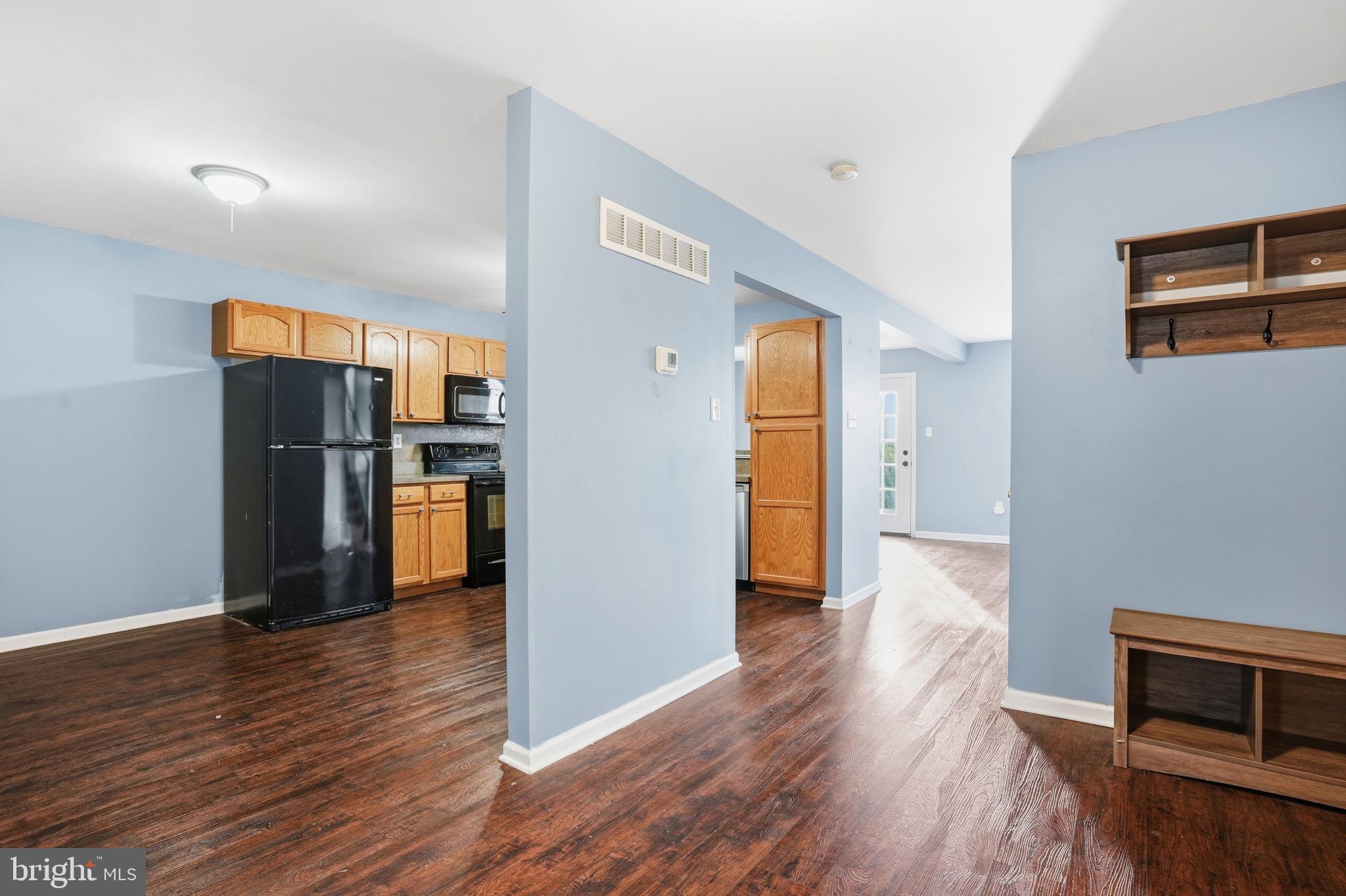 737 Seminary Street Pennsburg, PA 18073 - Photo 4 of 30 a view of a refrigerator in kitchen and wooden floor