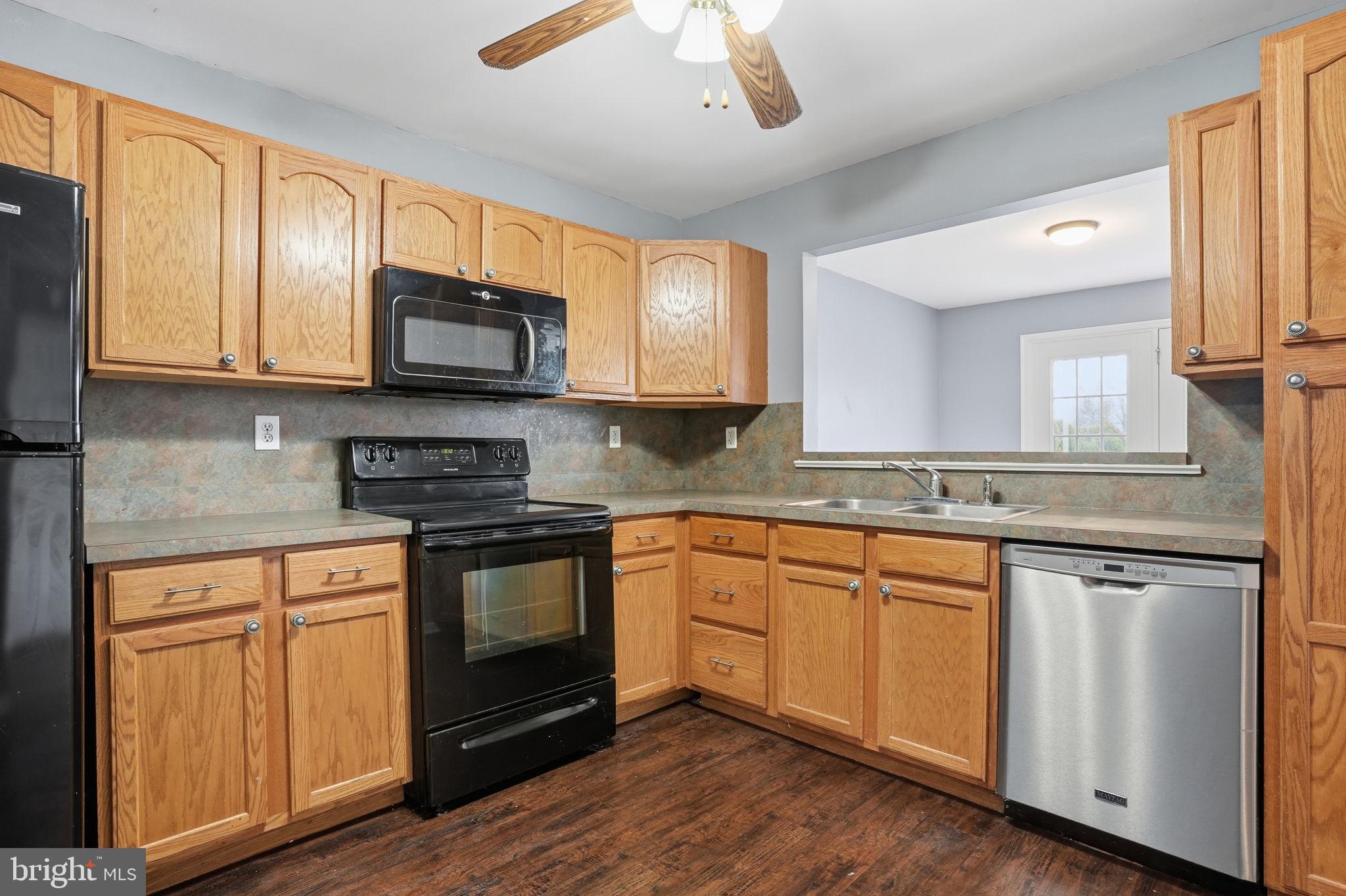 737 Seminary Street Pennsburg, PA 18073 - Photo 6 of 30 a kitchen with stainless steel appliances granite countertop a stove a sink and a microwave