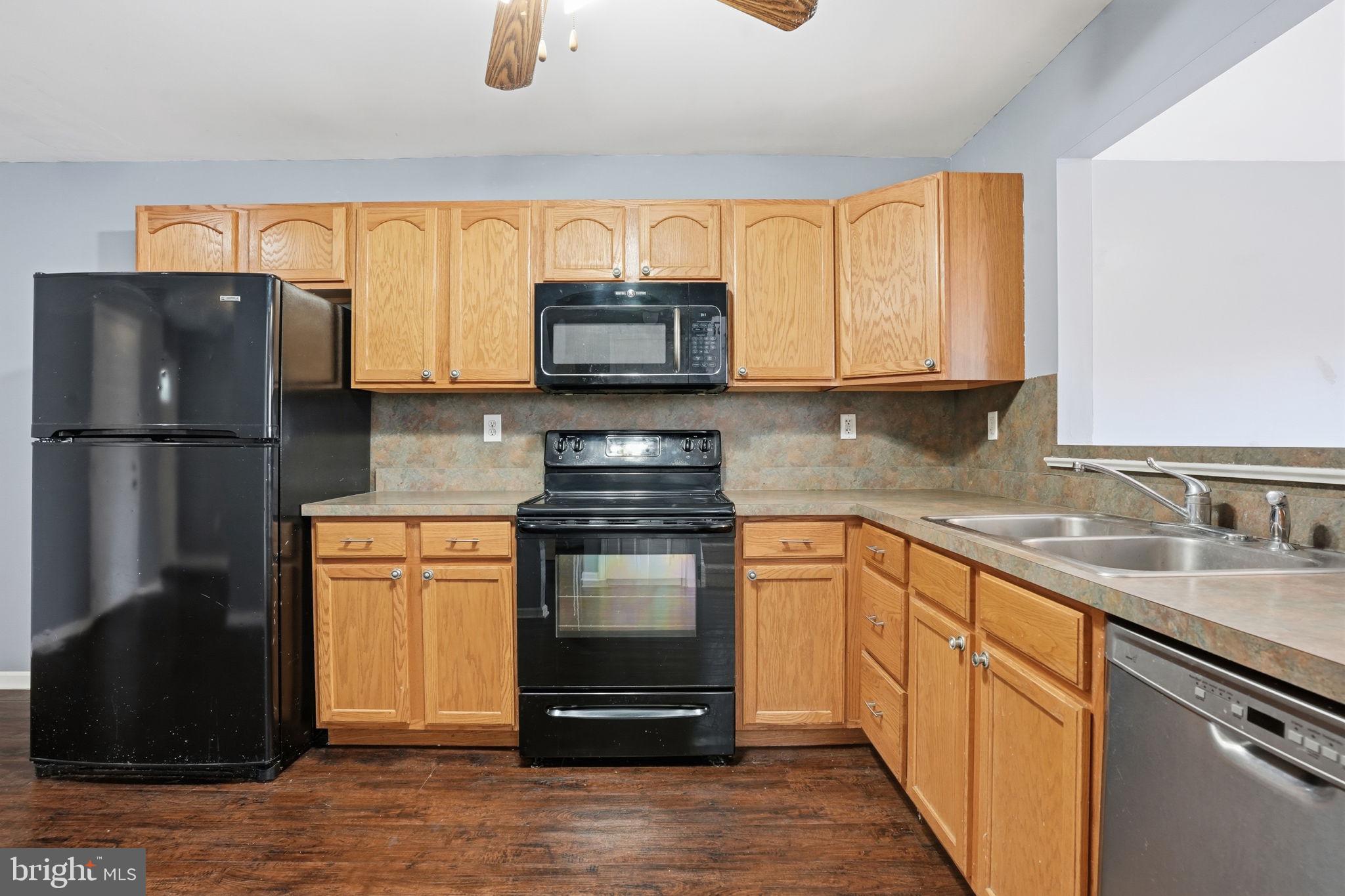 737 Seminary Street Pennsburg, PA 18073 - Photo 7 of 30 a kitchen with stainless steel appliances granite countertop a refrigerator stove and microwave