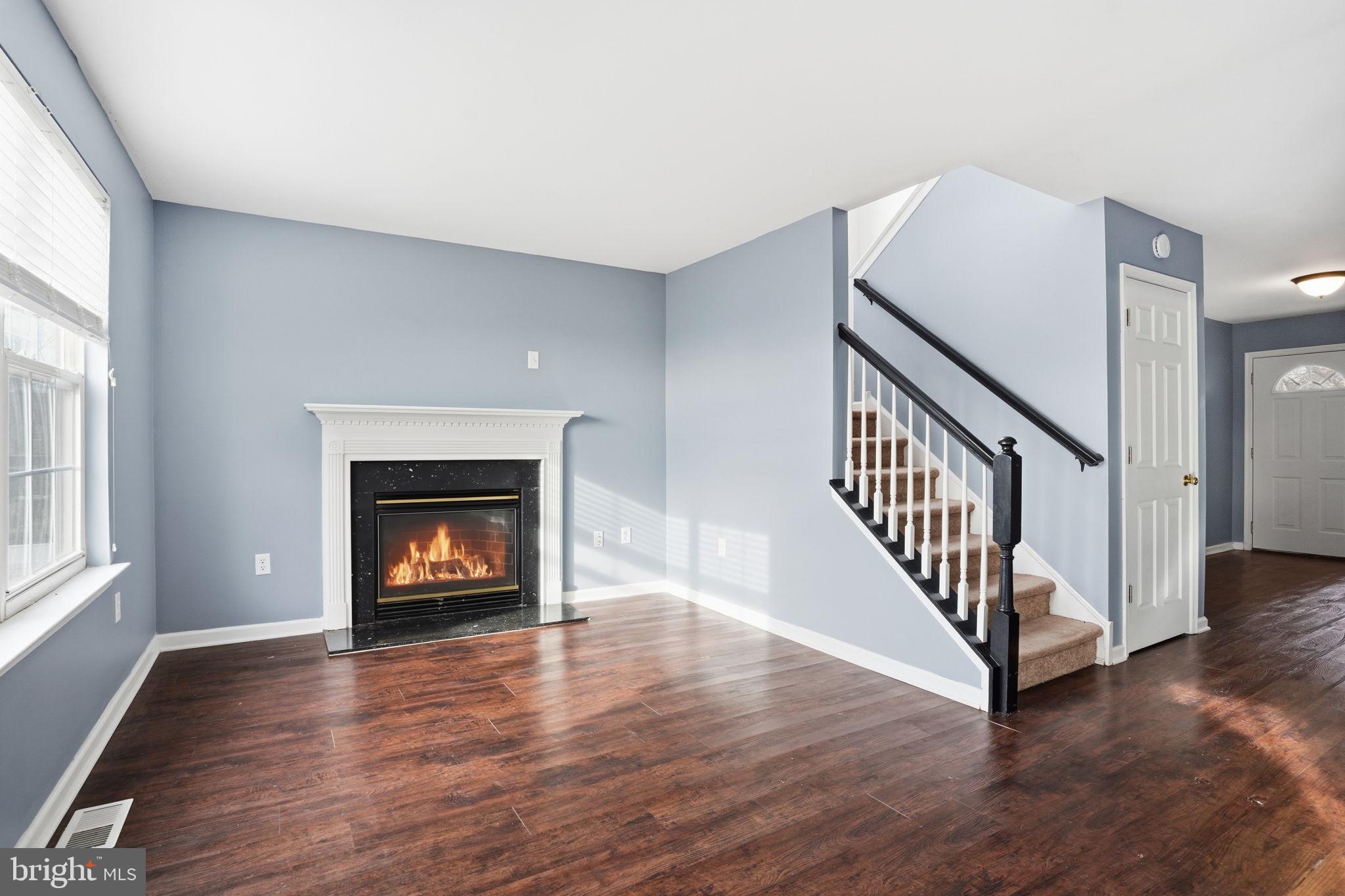 737 Seminary Street Pennsburg, PA 18073 - Photo 10 of 30 a view of an empty room with wooden floor fireplace and a window