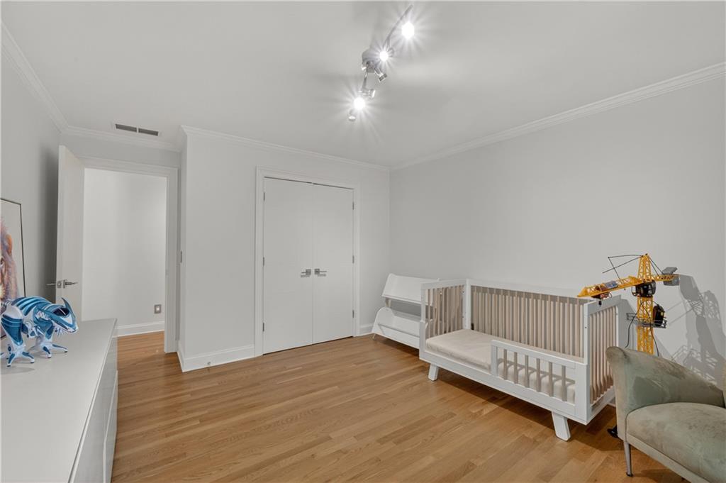 4610 West Morton Road Alpharetta, GA 30022 - Photo 20 of 53 a view of a bedroom with furniture and wooden floor