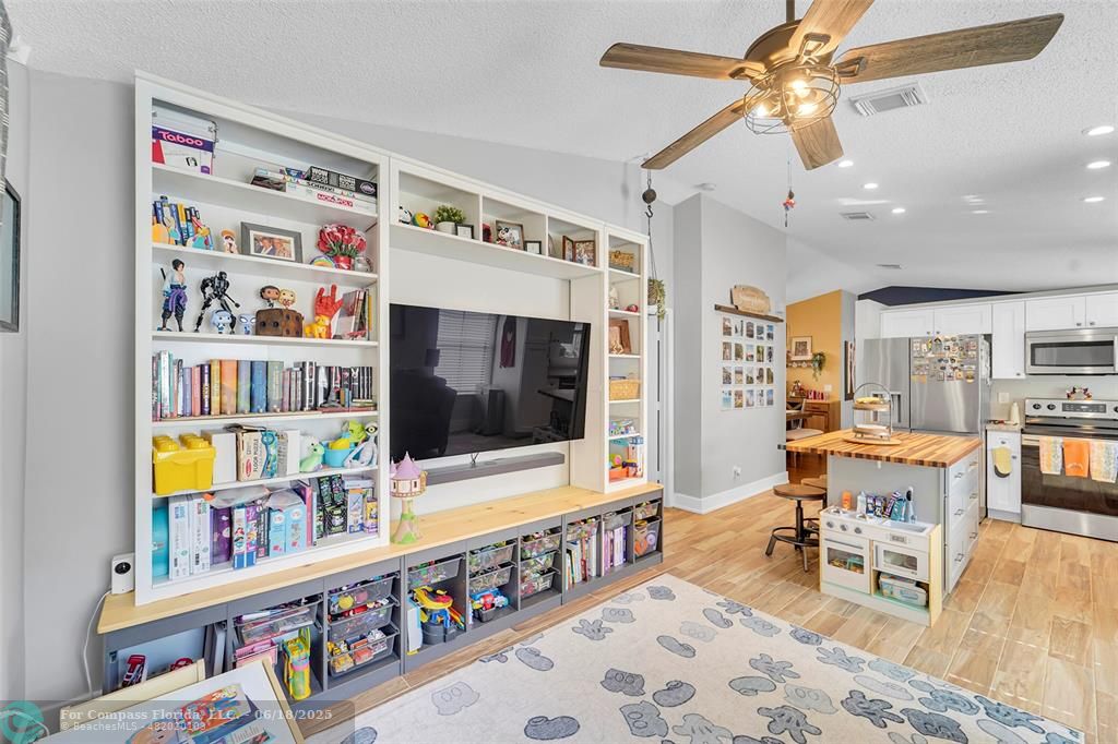 7542 Northwest 3rd Street Plantation, FL 33317 - Photo 12 of 31 a living room with furniture and a flat screen tv