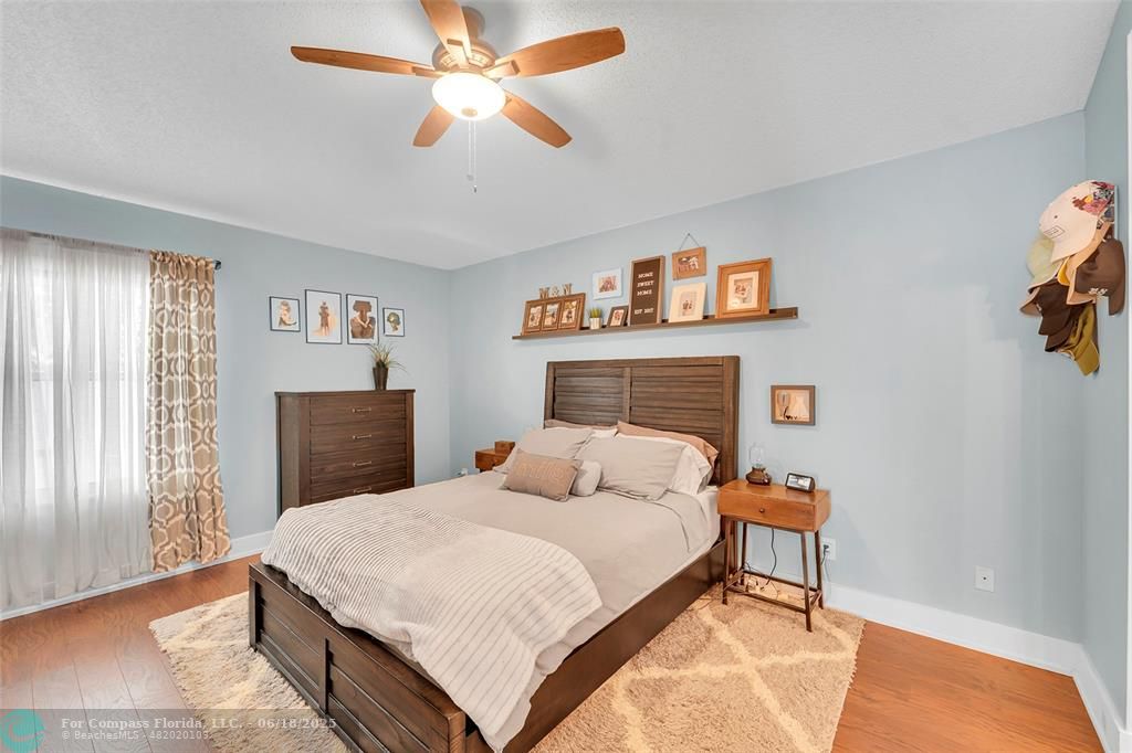 7542 Northwest 3rd Street Plantation, FL 33317 - Photo 16 of 31 a bedroom with a bed and a chandelier