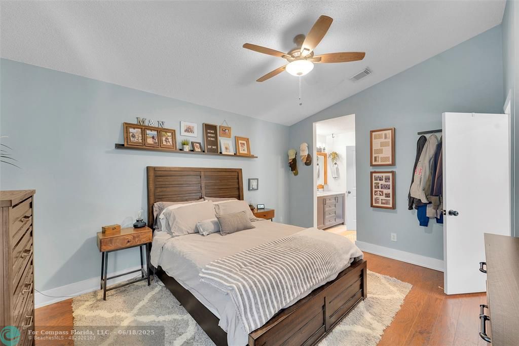7542 Northwest 3rd Street Plantation, FL 33317 - Photo 17 of 31 a bedroom with a large bed and a chandelier