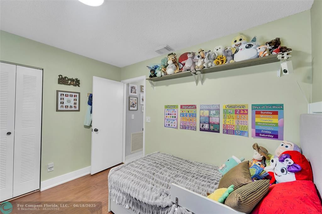 7542 Northwest 3rd Street Plantation, FL 33317 - Photo 23 of 31 a bedroom with a bed and dresser