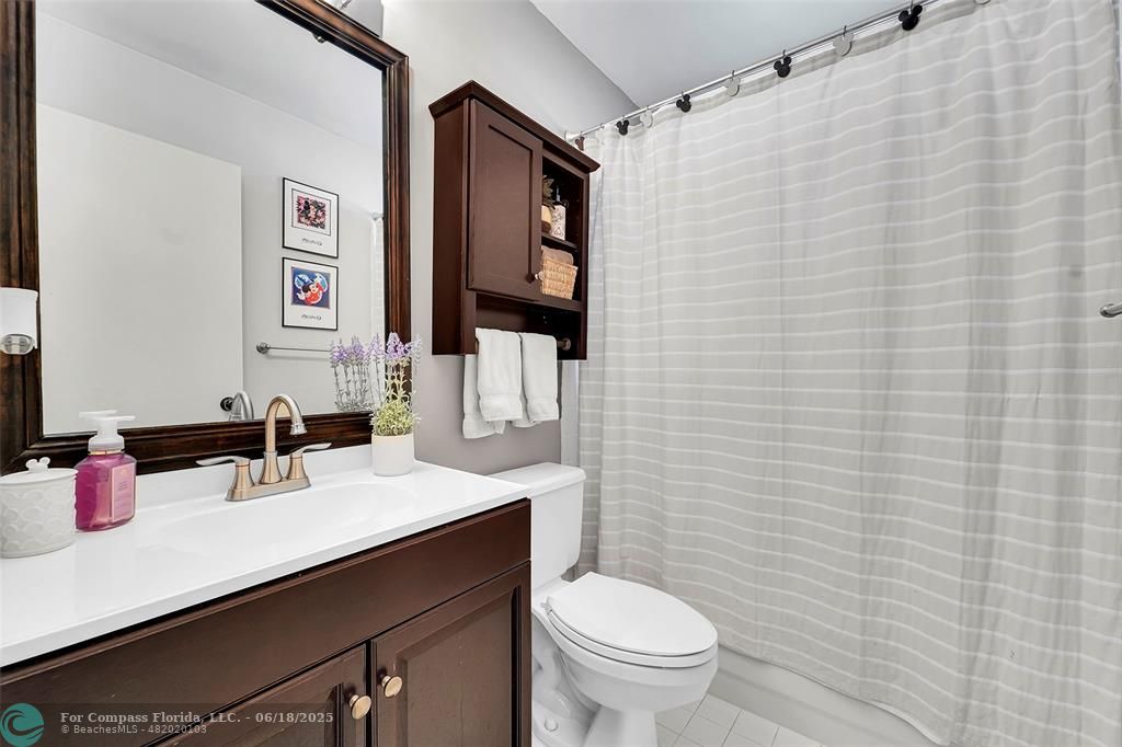 7542 Northwest 3rd Street Plantation, FL 33317 - Photo 24 of 31 a bathroom with a sink a toilet and shower curtain
