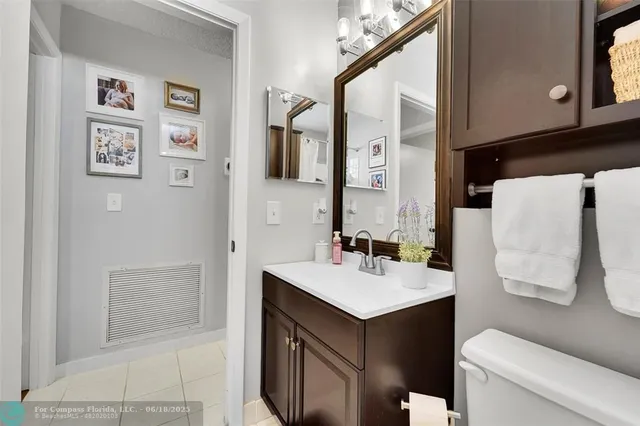 a bathroom with a sink toilet and mirror