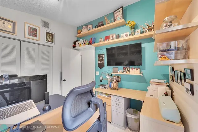 a living room with furniture a flat screen tv and a floor to ceiling window