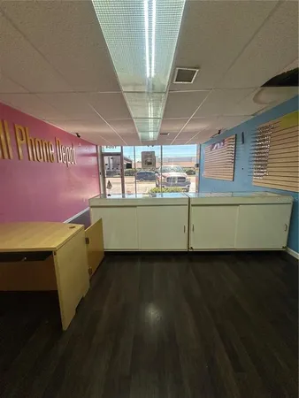 a view of a room with wooden floor