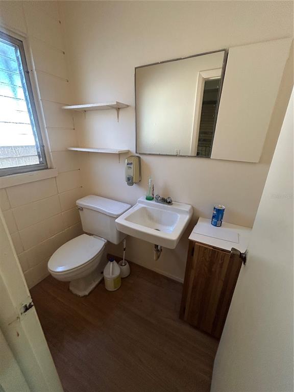 1864 Drew Street Clearwater, FL 33765 - Photo 5 of 6 a bathroom with a toilet sink and mirror