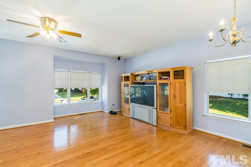5145 Sandy Banks Road Raleigh, NC 27616 - Photo 15 of 30 a view of an empty room with window and wooden floor