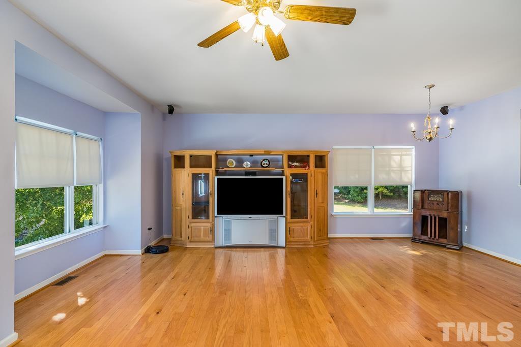 5145 Sandy Banks Road Raleigh, NC 27616 - Photo 17 of 30 an empty room with windows and a fireplace
