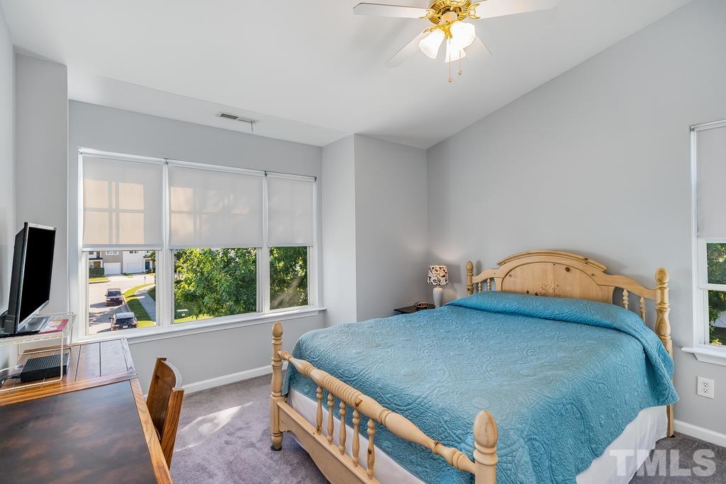 5145 Sandy Banks Road Raleigh, NC 27616 - Photo 20 of 30 a bedroom with a bed a window and a flat screen television