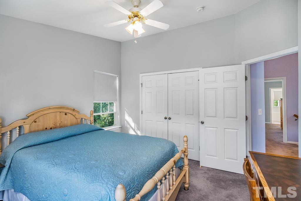 5145 Sandy Banks Road Raleigh, NC 27616 - Photo 21 of 30 a bedroom with a bed and a chandelier