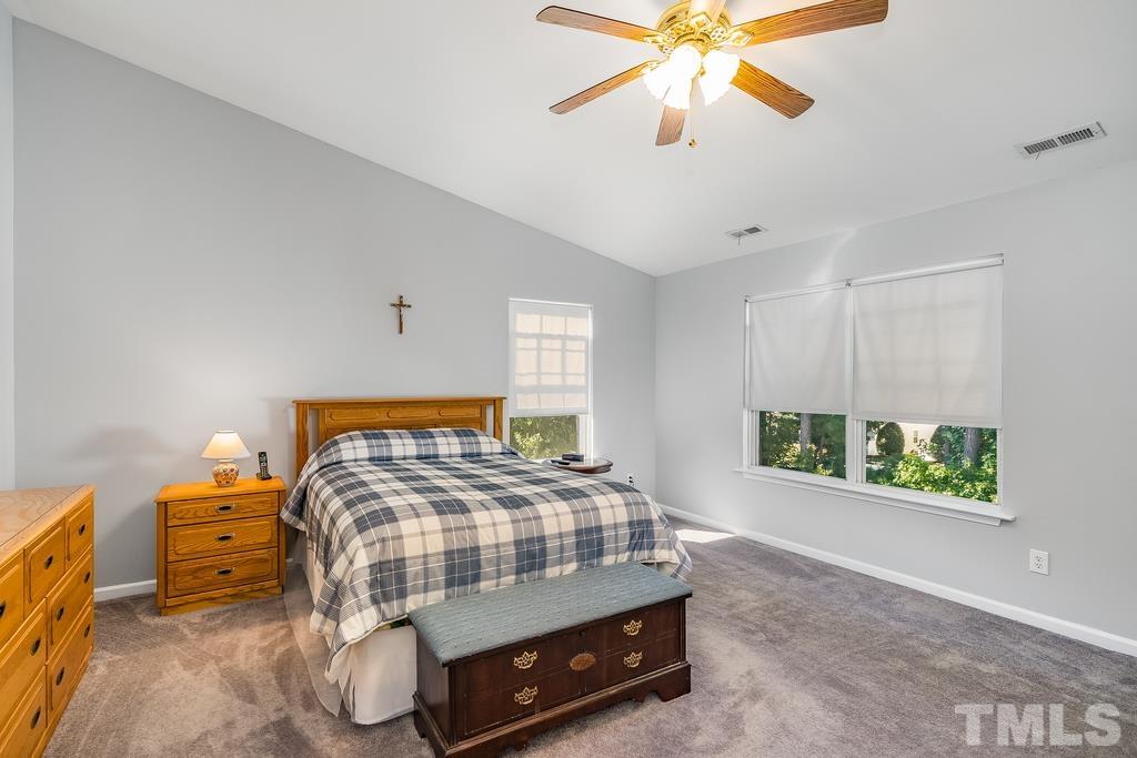 5145 Sandy Banks Road Raleigh, NC 27616 - Photo 23 of 30 a bedroom with a bed and a chandelier