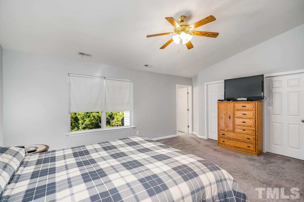 5145 Sandy Banks Road Raleigh, NC 27616 - Photo 24 of 30 a bedroom with a bed and a ceiling fan