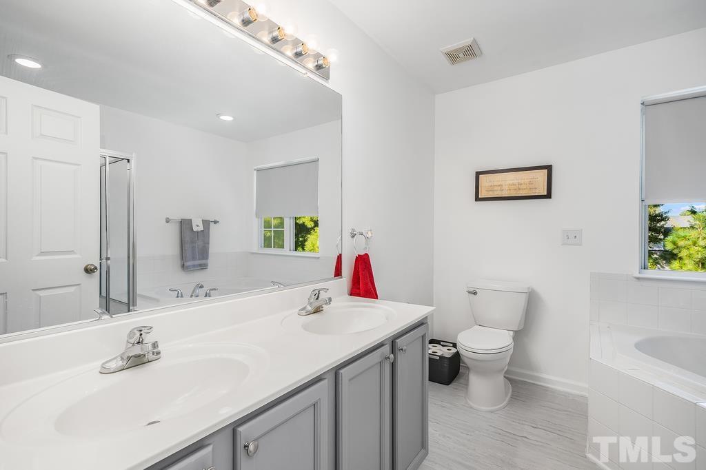 5145 Sandy Banks Road Raleigh, NC 27616 - Photo 26 of 30 a bathroom with a toilet sink and mirror