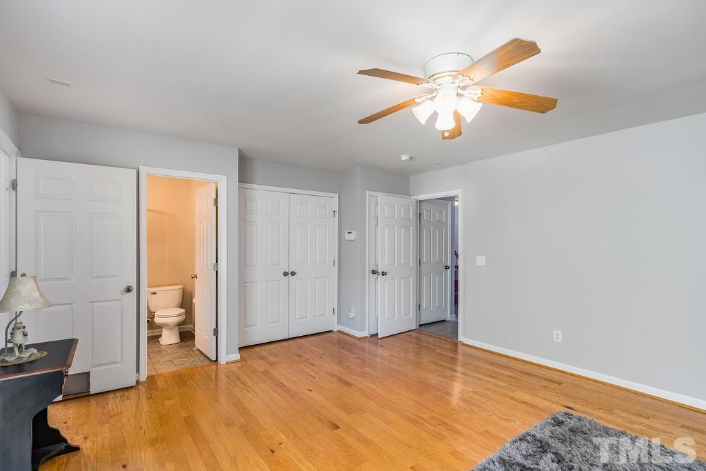 5145 Sandy Banks Road Raleigh, NC 27616 - Photo 7 of 30 a bedroom with a bed and a chandelier