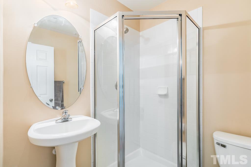 5145 Sandy Banks Road Raleigh, NC 27616 - Photo 8 of 30 a bathroom with a sink a mirror and a shower