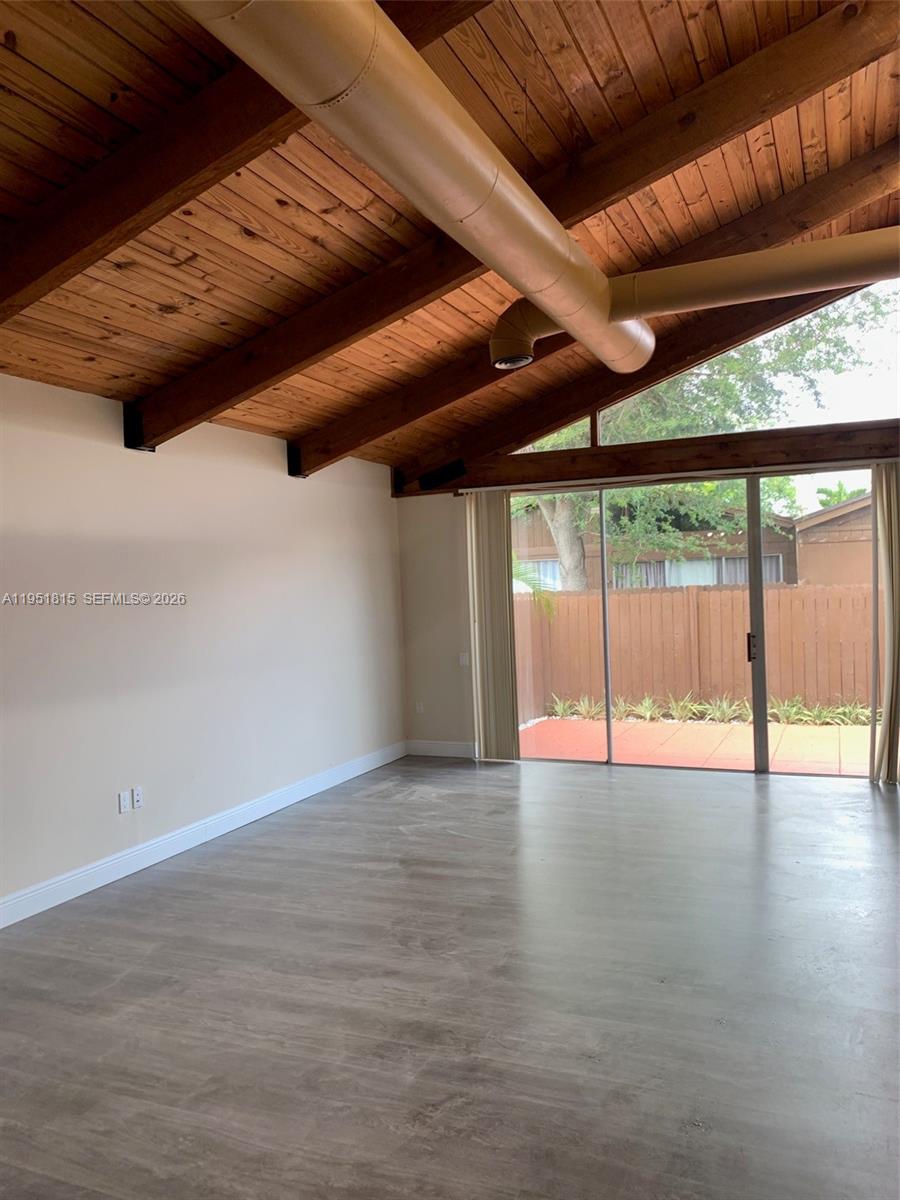 11318 Southwest 114th Cir Terrace Miami, FL 33176 - Photo 11 of 30 a view of an empty room with wooden floor and a window