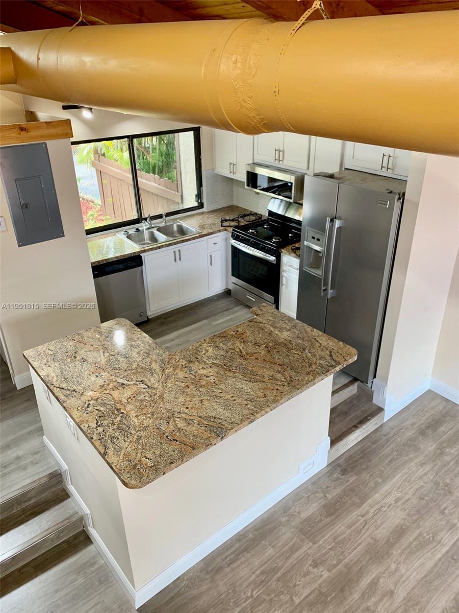 11318 Southwest 114th Cir Terrace Miami, FL 33176 - Photo 22 of 30 a kitchen with stainless steel appliances granite countertop a sink stove and refrigerator