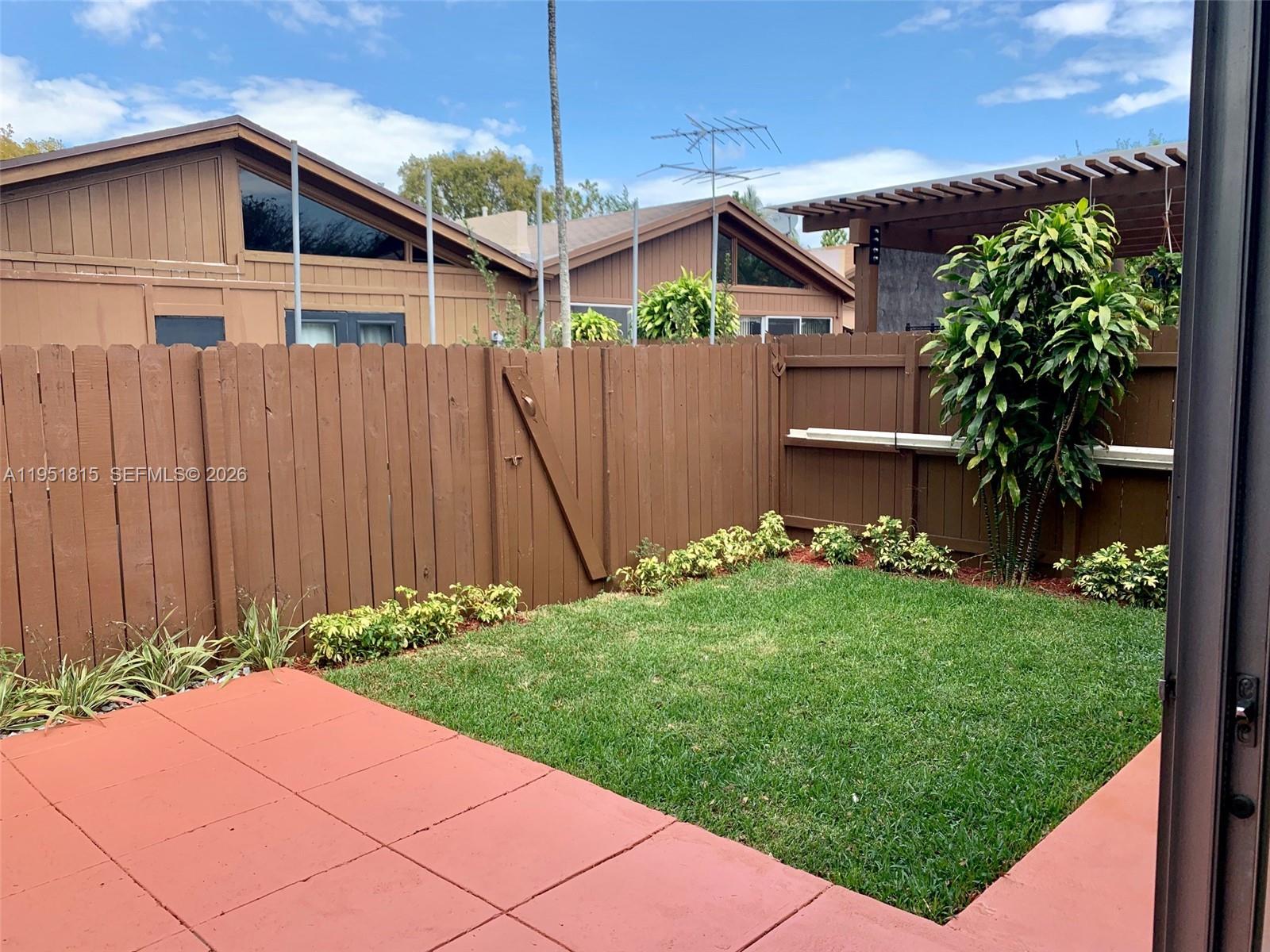 11318 Southwest 114th Cir Terrace Miami, FL 33176 - Photo 25 of 30 a front view of a house with garden