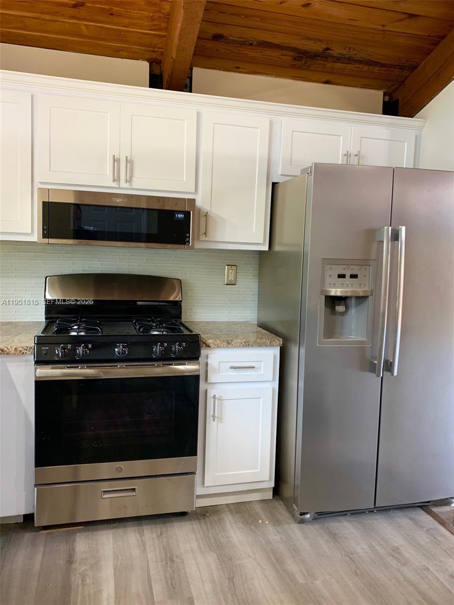 11318 Southwest 114th Cir Terrace Miami, FL 33176 - Photo 7 of 30 a stove top oven sitting inside of a kitchen