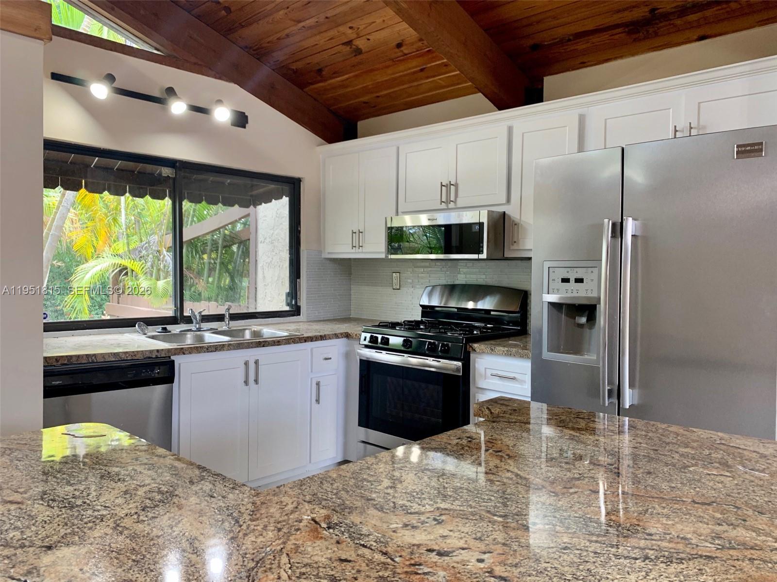 11318 Southwest 114th Cir Terrace Miami, FL 33176 - Photo 9 of 30 a kitchen with granite countertop a stove a sink a refrigerator and a stove
