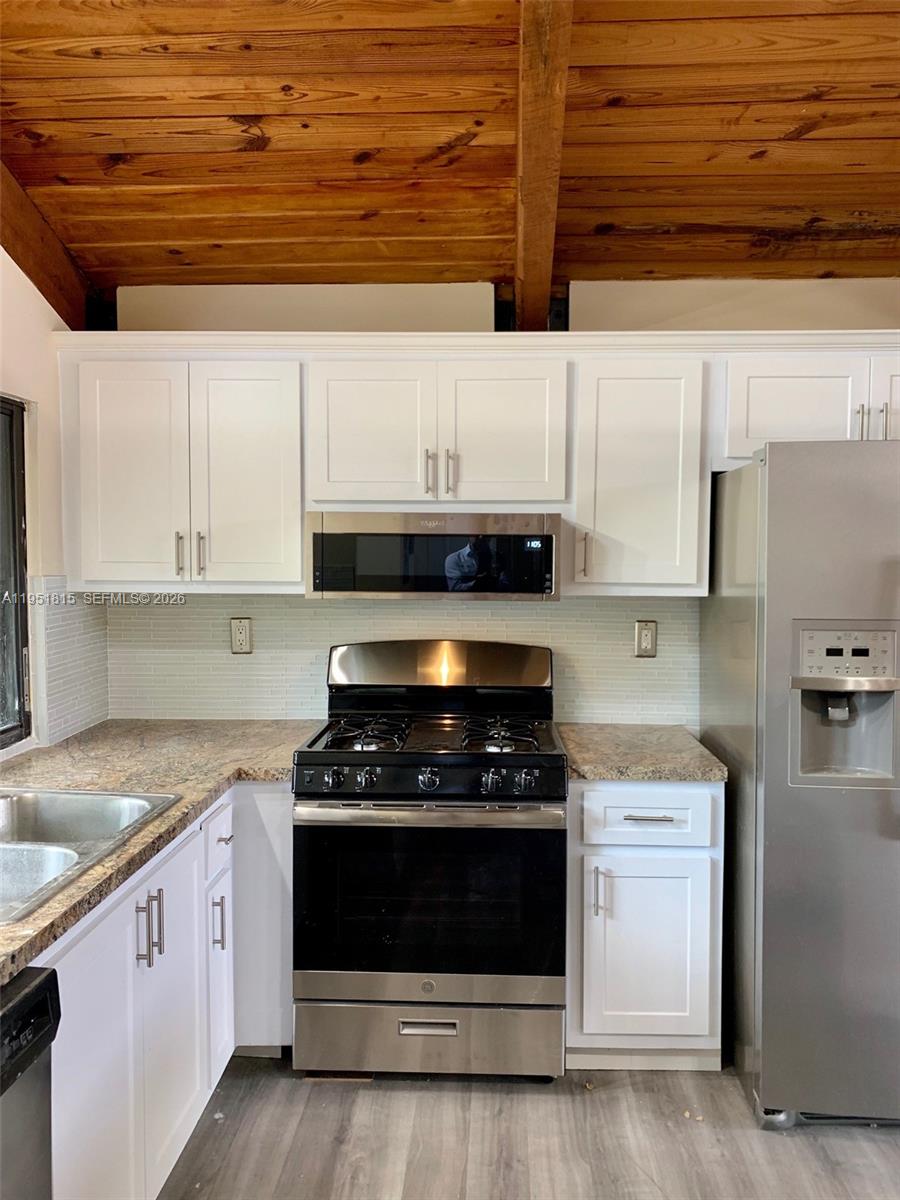 11318 Southwest 114th Cir Terrace Miami, FL 33176 - Photo 10 of 30 a kitchen with stainless steel appliances granite countertop a stove and a sink