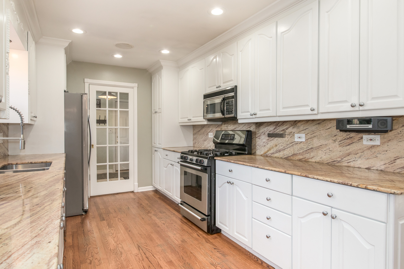 2240 Birch Street Park Ridge, IL 60068 - Photo 5 of 21 a kitchen with granite countertop white cabinets and stainless steel appliances