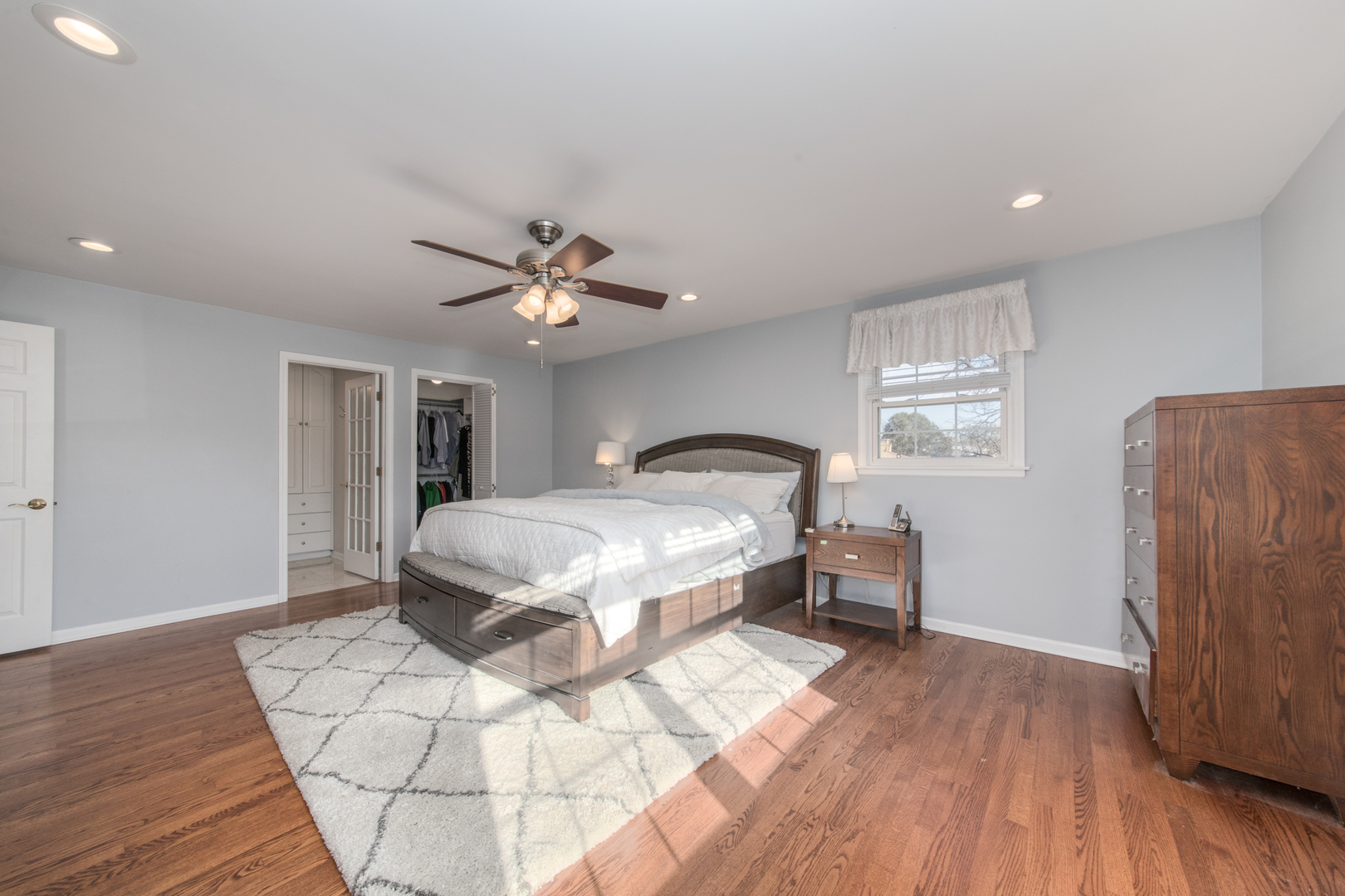 2240 Birch Street Park Ridge, IL 60068 - Photo 8 of 21 a spacious bedroom with a bed and a chandelier