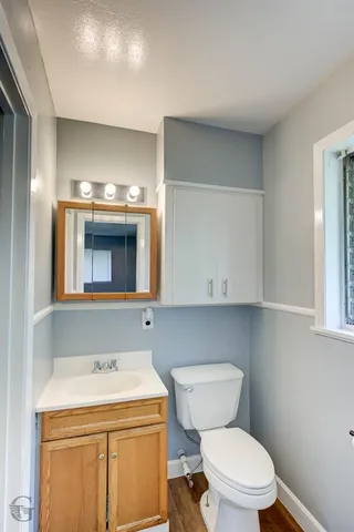 a bathroom with a stove a sink and a microwave