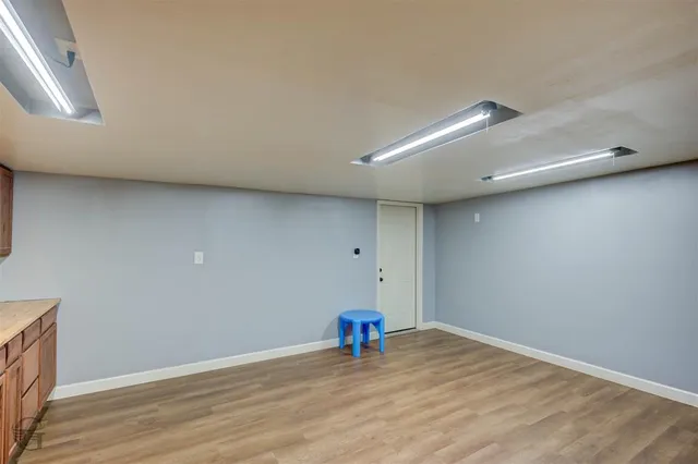 a view of a room with wooden floor and entryway