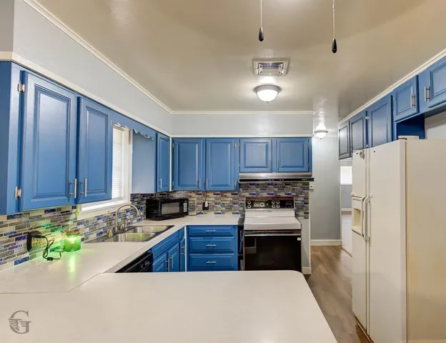 a kitchen with a refrigerator sink and stove