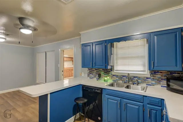 a kitchen with sink cabinets and window