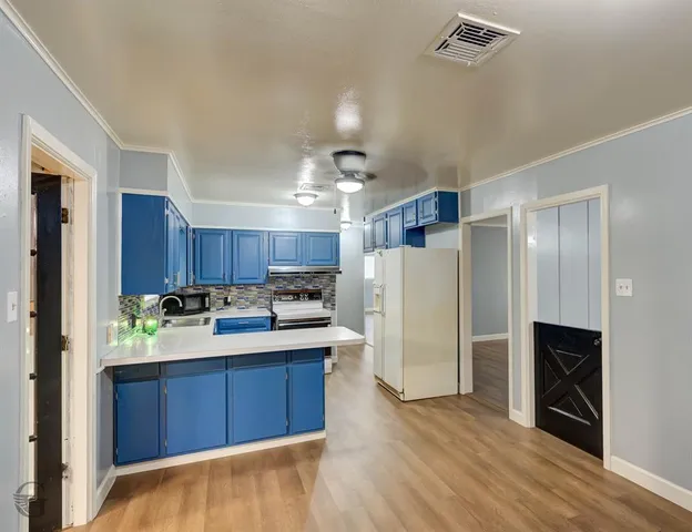 a kitchen with a refrigerator and a sink