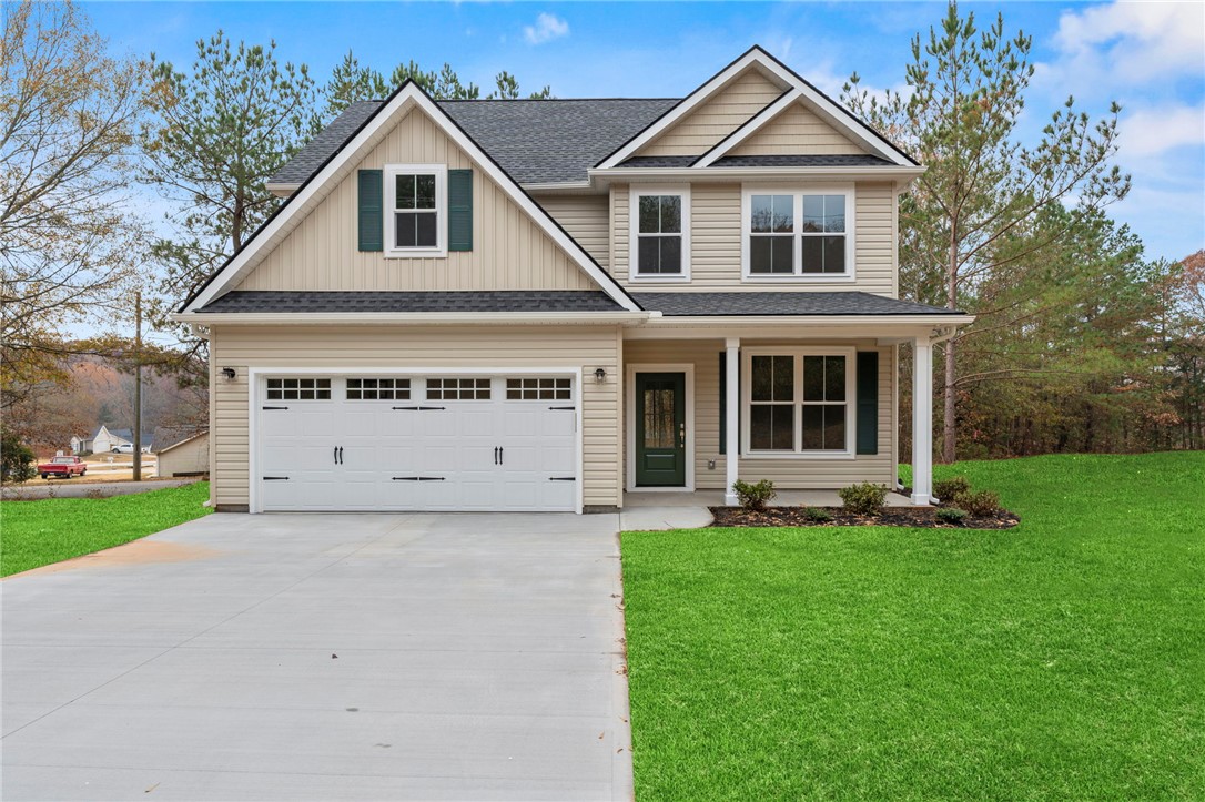 This newly constructed home features a welcoming facade and ample outdoor space.
