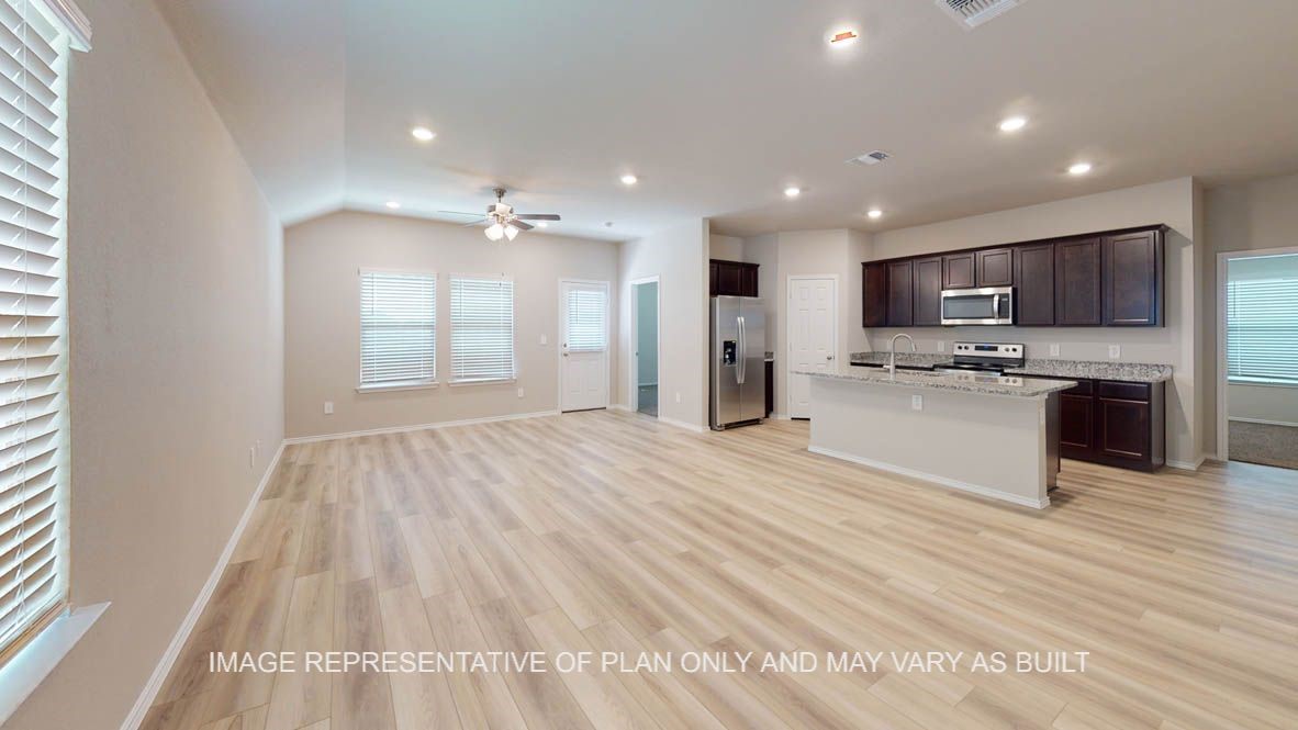 a view of kitchen with sink and refrigerator